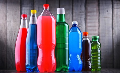 Plastic bottles of assorted carbonated soft drinks in variety of colors