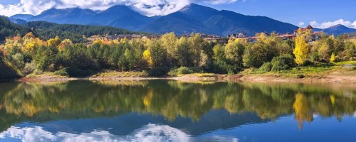 Bansko, Bulgaria autumn banner panorama background of Pirin mountain peaks, Krinets lake water,