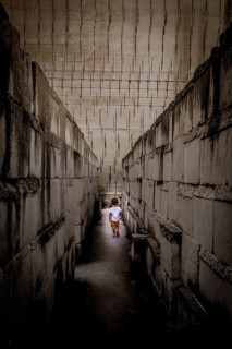 Caucasian young kid walking with labyrinth perspective. Conceptual image for dangerous situation