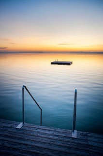 Sunset at Weiden on the lake with ladder and swimming island