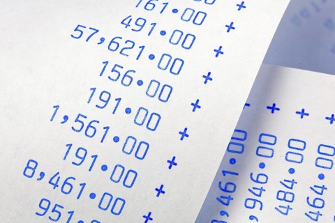 Calculation strip with numbers. Symbol for costs, expenses, turnover and profit. / Computing