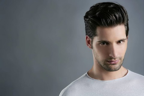 Fashion trendy young man silver futuristic portrait over gray