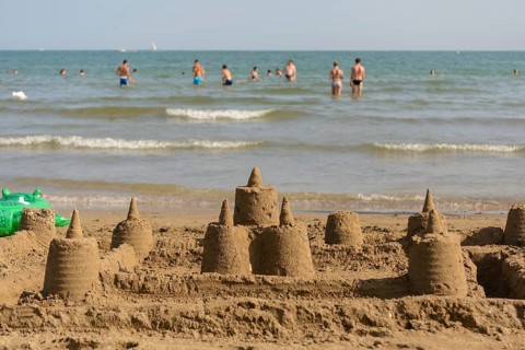 Several sandcastles on the beach off the coast - beach holiday
