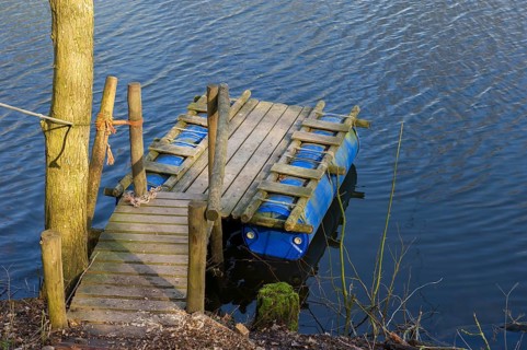 Handmade raft from shelves and plastic containers in the water