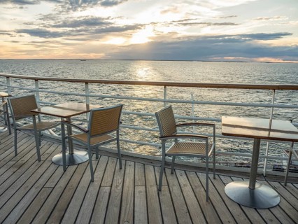 Terrace on the sea at sunset, empty tables and chairs, quiet atmosphere, svaneke, bornholm, baltic