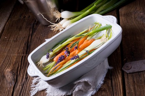 Young carrots and spring onions prepared for baking