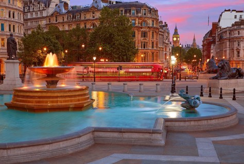 London Trafalgar Square fountain at sunset England