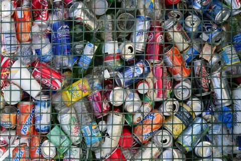 Assorted beverages cans on the trash, colored texture