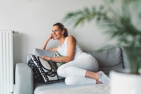 Cheerful happy caucasian woman relaxing at home on her day off work. Adult content woman spending