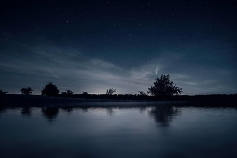 An image of a night scenery with comet Neowise