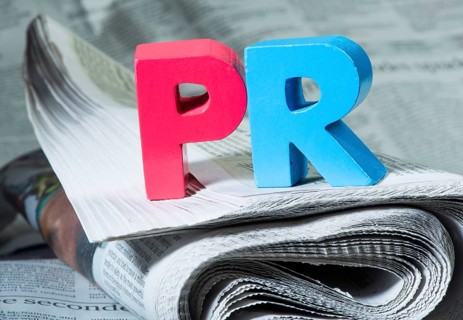 Word PR on newspaper. Wooden letters