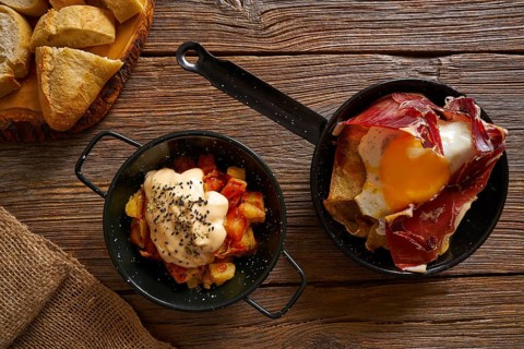 Tapas from spain broken eggs and bravas potatoes