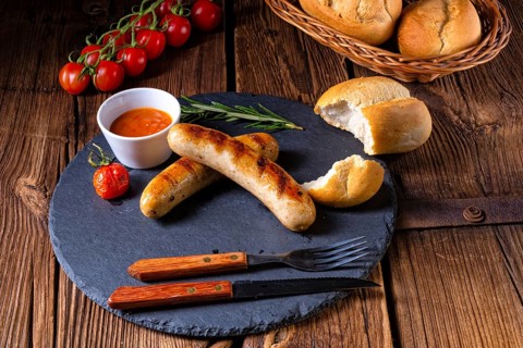 Rustic bratwurst with ketchup and fresh rolls