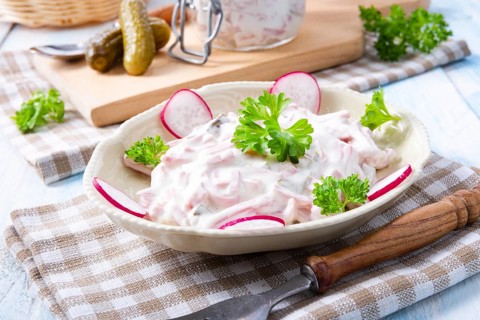 Delicious homemade meat salad with mayonnaise and cucumber