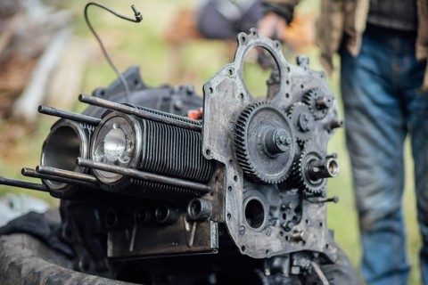View of mechanical parts of an engine being repaired outside