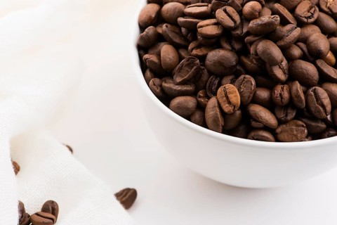 Bowl of caffee beans on a white background