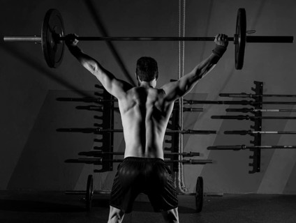 Barbell weight lifting man rear view back workout exercise at gym box