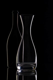 Empty glass and bottles on the black background