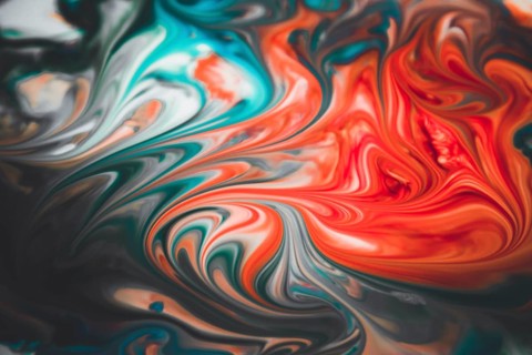 Colorful liquid paints mixed together creating modern abstract