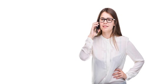 Smiling businesswoman in glasses talking on mobile phone. Beautiful young girl in white shirt on