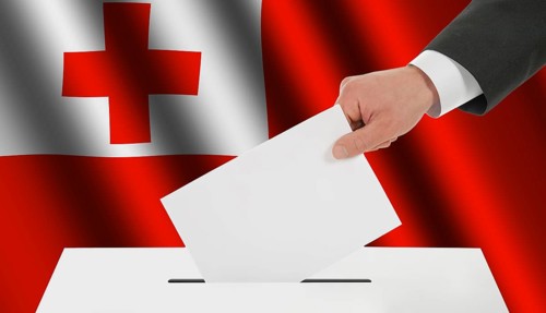 The Tonga flag and the hand with the bulletin about the ballot box
