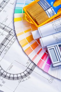 Rolled blueprints and paint brushes in tray calculator on color palette