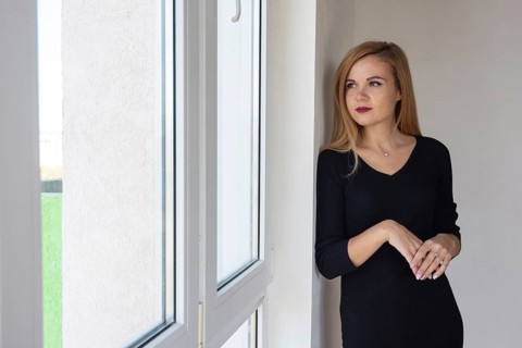 Beautiful girl looks in a new apartment in a new building