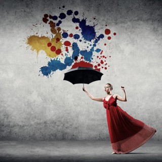 Passionate woman dancer in red dress with black umbrella in hand