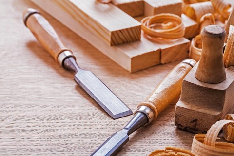 Chisels plane planks shavings on wooden board