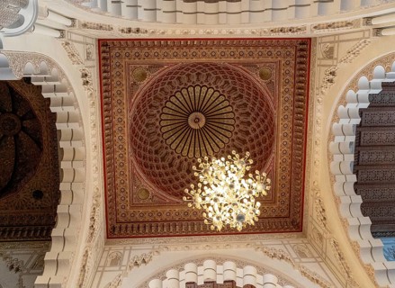 Casablanca, Morocco, 29 March, 2024: detail view of an ornate cedarwood ceiling and chandelier