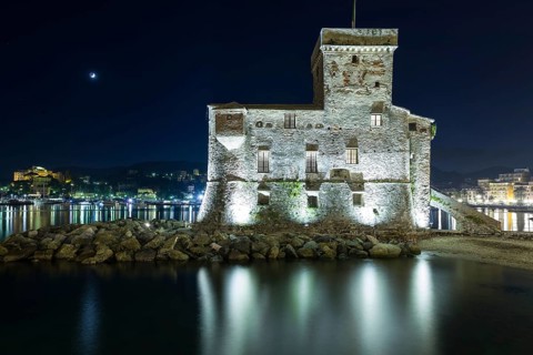 The ancient castle of Rapallo, built on the ligurian sea illuminated by night