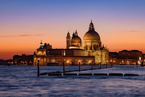 Santa Maria della Salute (Saint Mary of Health) at sunset time, a Catholic church in Venice, Italy,