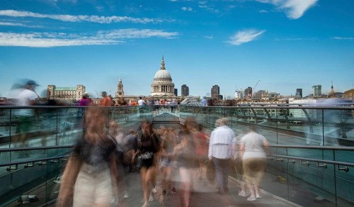 London, UK, July 5, 2019: People walking on the millennium bridge and Saint Paul Cathedral in