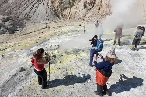 KAMCHATKA, RUSSIA, SEPTEMBER 11, 2013: Group photographers takes picture volcanic landscape, hot
