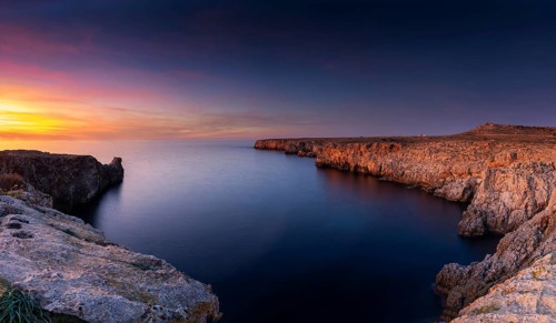 Landscape view of cliffs and rugged shorelina at Pont d'en Gil in northeastern Menorca near