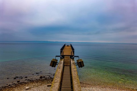 Waterfront and a Pier on Lake Neuchatel in Old Town in a Foggy Winter day in City of Neuchatel,