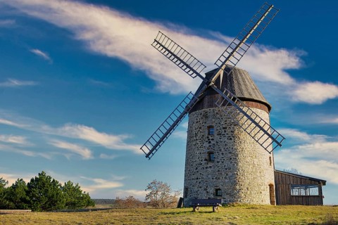 A windmill in the field in the daytime