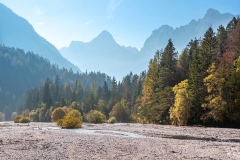 Scenic autumn forest at Crystal Lake in the Julian Alps, Slovenia, Europe