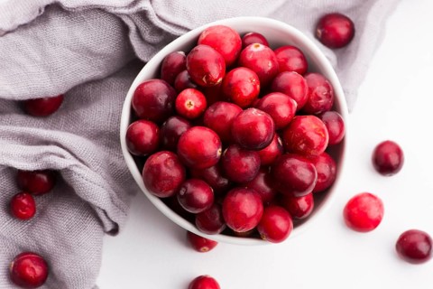 Ceramic bowl of Cranberry on white background