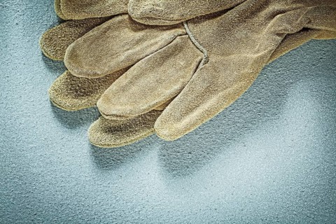 Protective gloves on concrete surface construction concept
