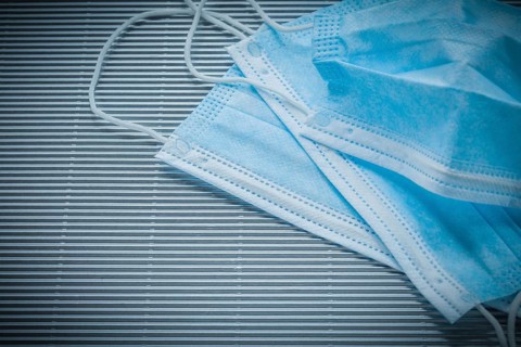 Medical disposable face masks on striped background