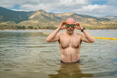 Active senior man finishing swimming workout in a mountain lake - Horsetooth Reservoir in northern