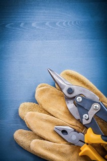 Pliers steel cutter pair of safety gloves on wooden board