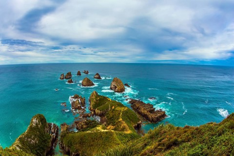 Nuggets Point is a landmark relief on the Otago coast, surrounded by rocky islets. Travel to New