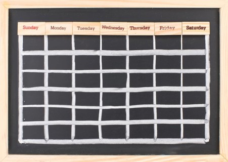 Monthly calendar with week words print on wood on blackboard