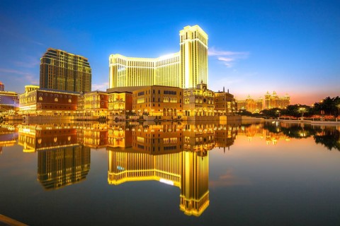 Scenic panorama cityscape of Macau, China, reflected on lake at sunset. Urban night scene, Asia