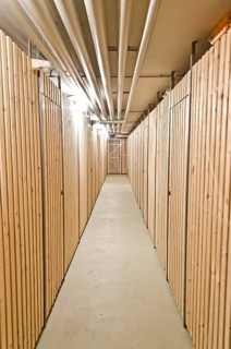 Aisle in a cellar with wooden storage units