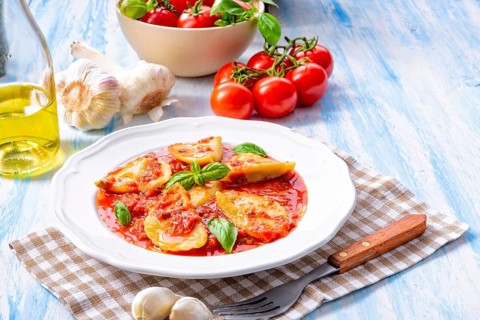 Delicious pasta - ravioli in tomato sauce with basil