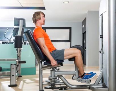 Hip abduction blond man exercise at gym indoor closing legs workout