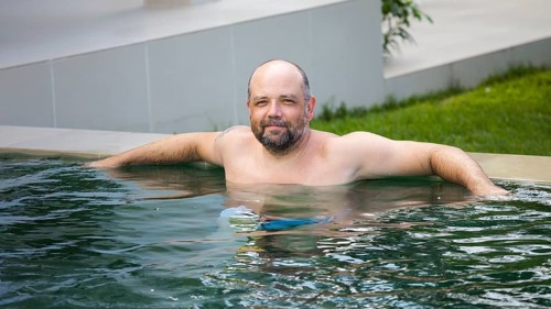 An image of a man relaxing in the pool